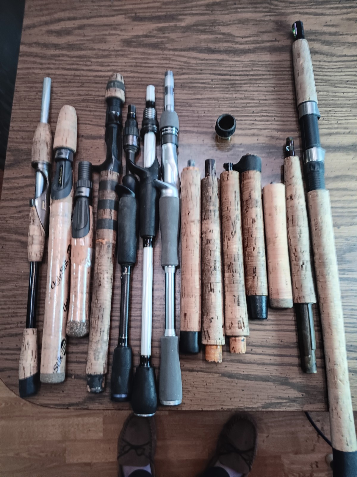 Lot of 14 handles from various used fishing rods.