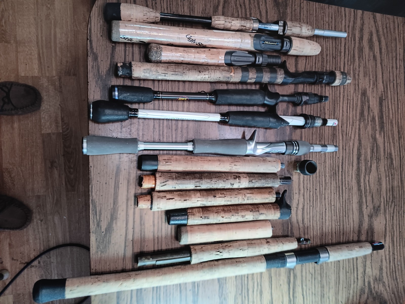 Lot of 14 handles from various used fishing rods.