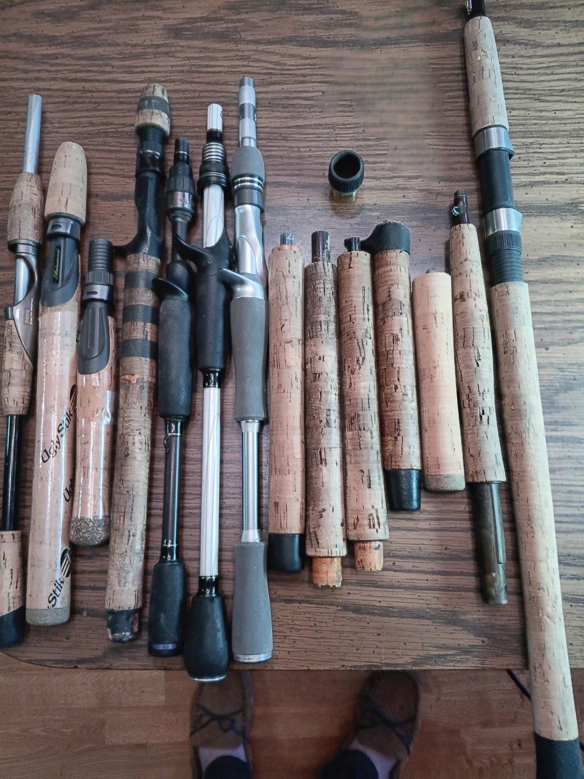 Lot of 14 handles from various used fishing rods.