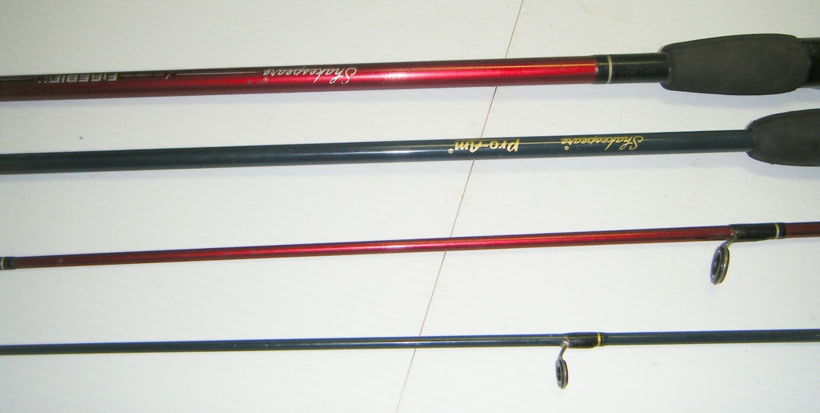 2 Shakespeare 2-Piece Spinning Rods- 1 Firebird 6’6” Med. – 1 Pro-Am 5’6” Light