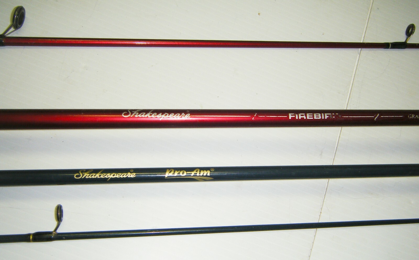 2 Shakespeare 2-Piece Spinning Rods- 1 Firebird 6’6” Med. – 1 Pro-Am 5’6” Light