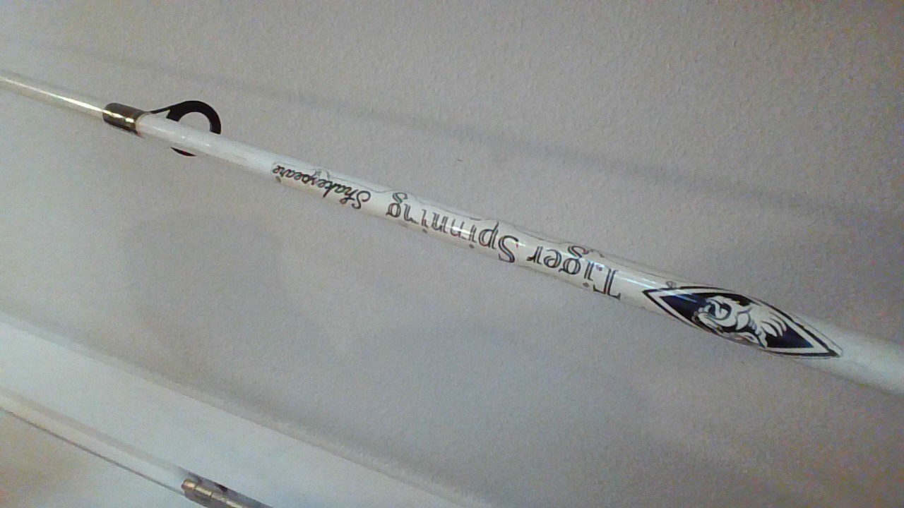 fishing rod white and black. Brand= Shakespearse. Good for redfish and snook.