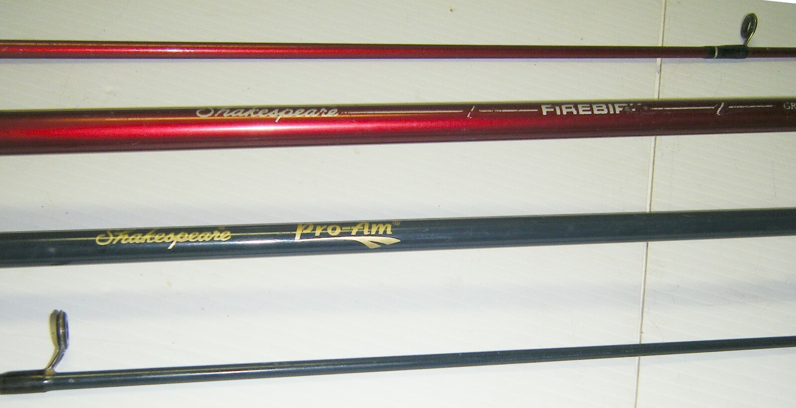2 Shakespeare 2-Piece Spinning Rods- 1 Firebird 6’6” Med. – 1 Pro-Am 5’6” Light